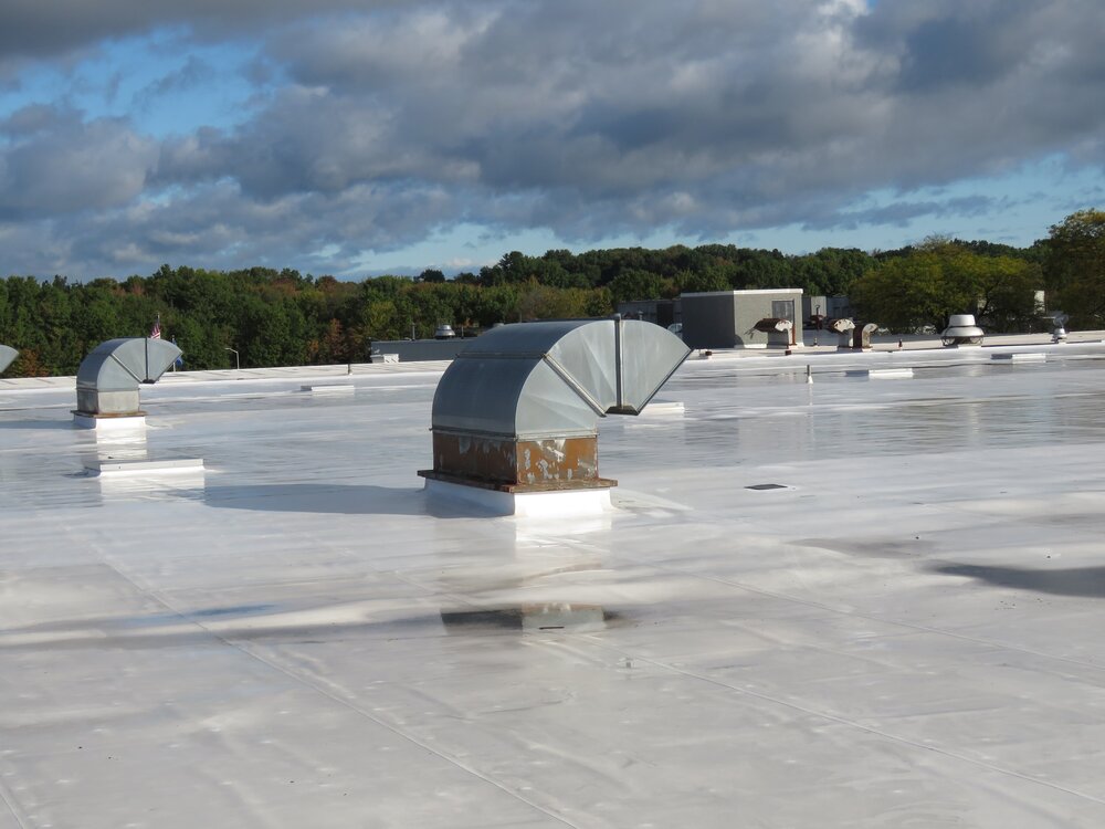 A CPE single-ply roofing membrane after a rain.