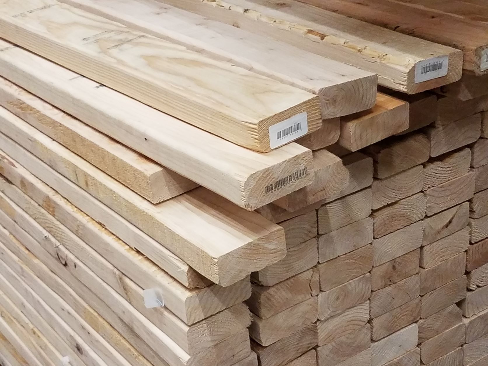 https://roofonline.com/wp-content/uploads/A-stack-of-2x4-lumber-boards.jpg