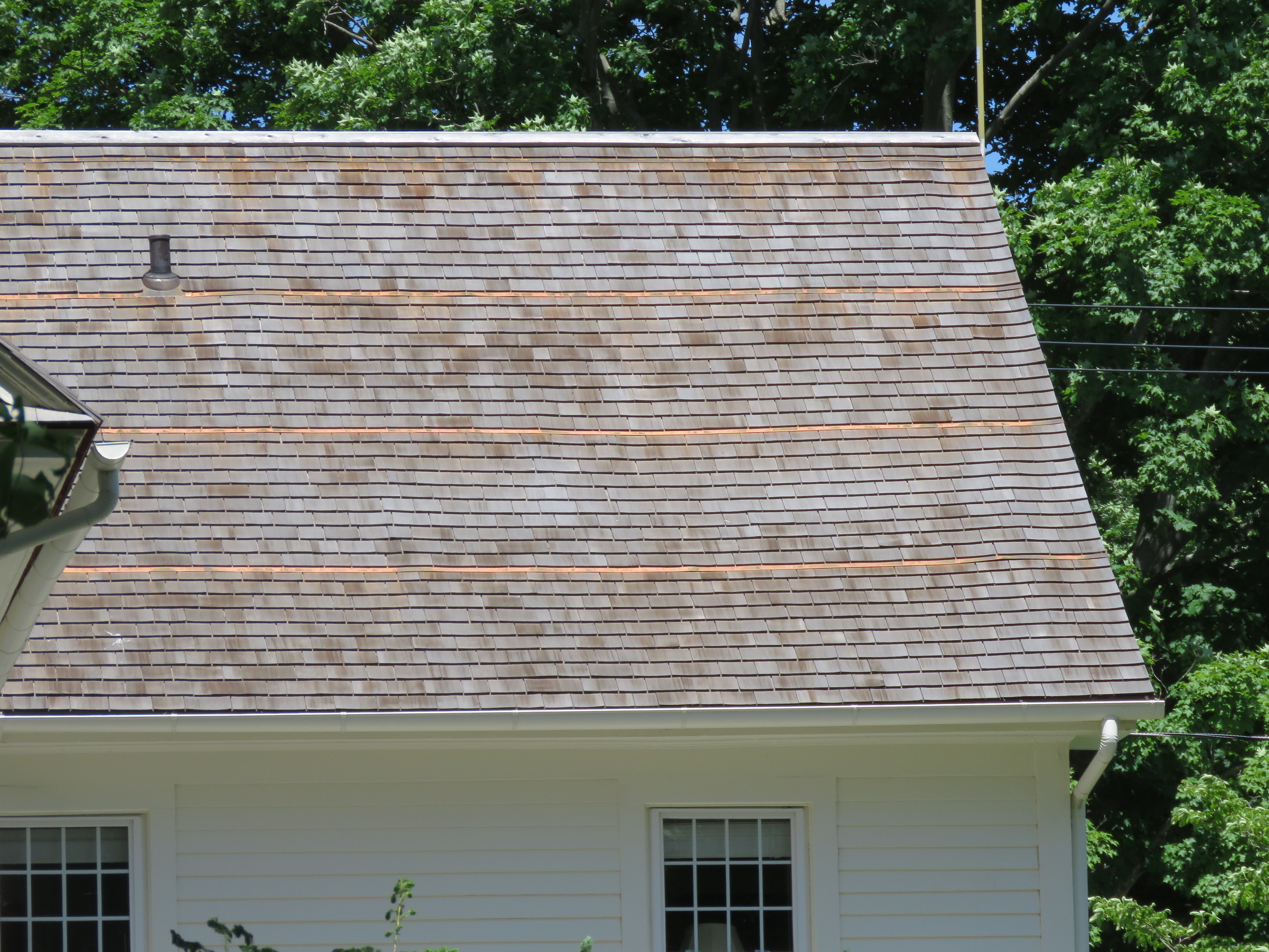 A fairly new cedar shingle roof. Note the copper strips installed to inhibit the growth of algae.