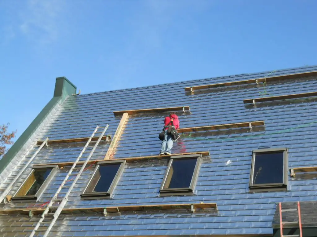 installing aluminum roof shingles.