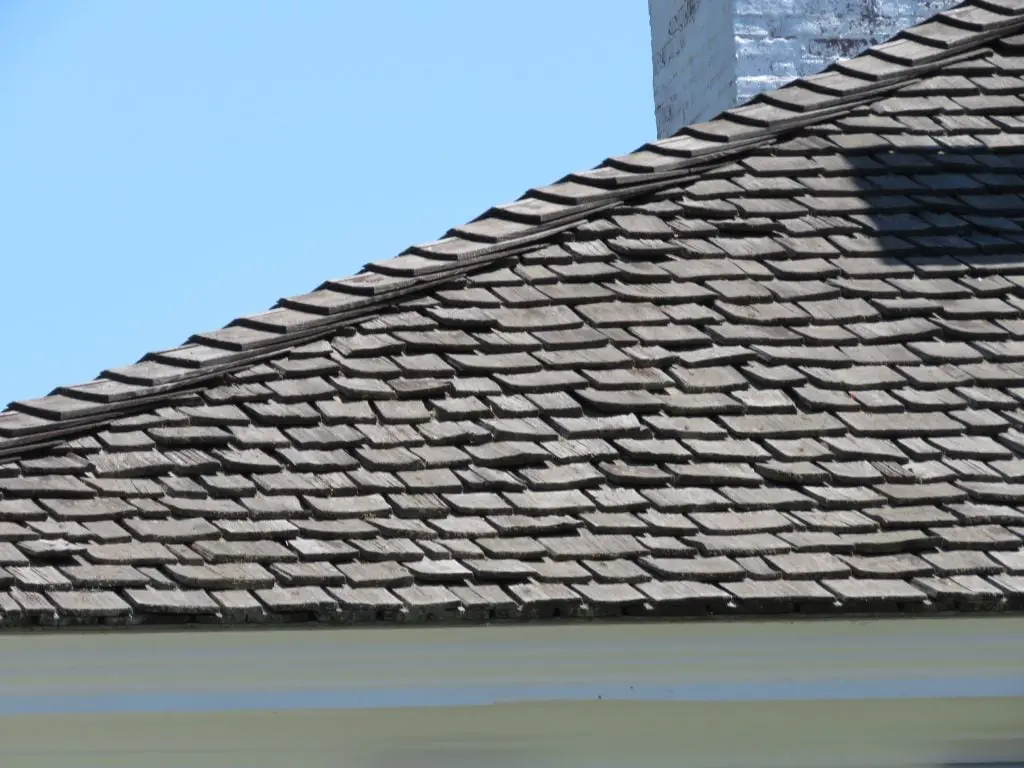 An aged wood shake roof.