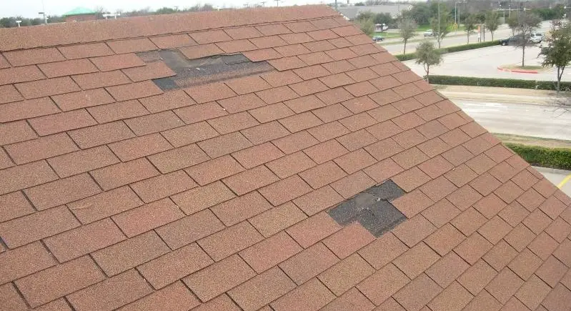 Avoid wind damaged shingles like this by using the best roof shingles.