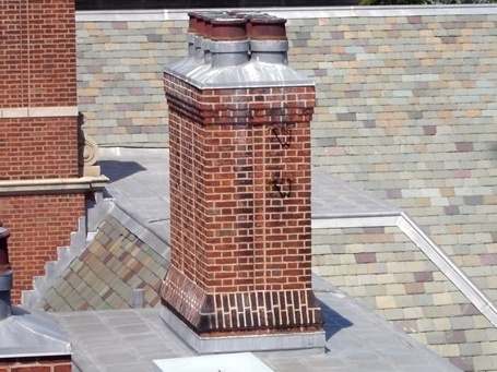 A chimney on a flat roof area.