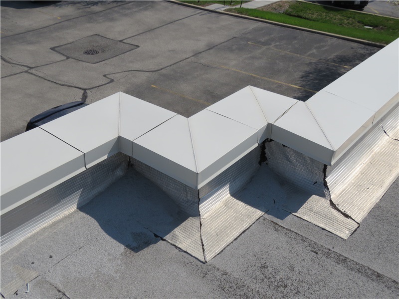 Coated aluminum parapet wall coping with pre-fabricated corners.
