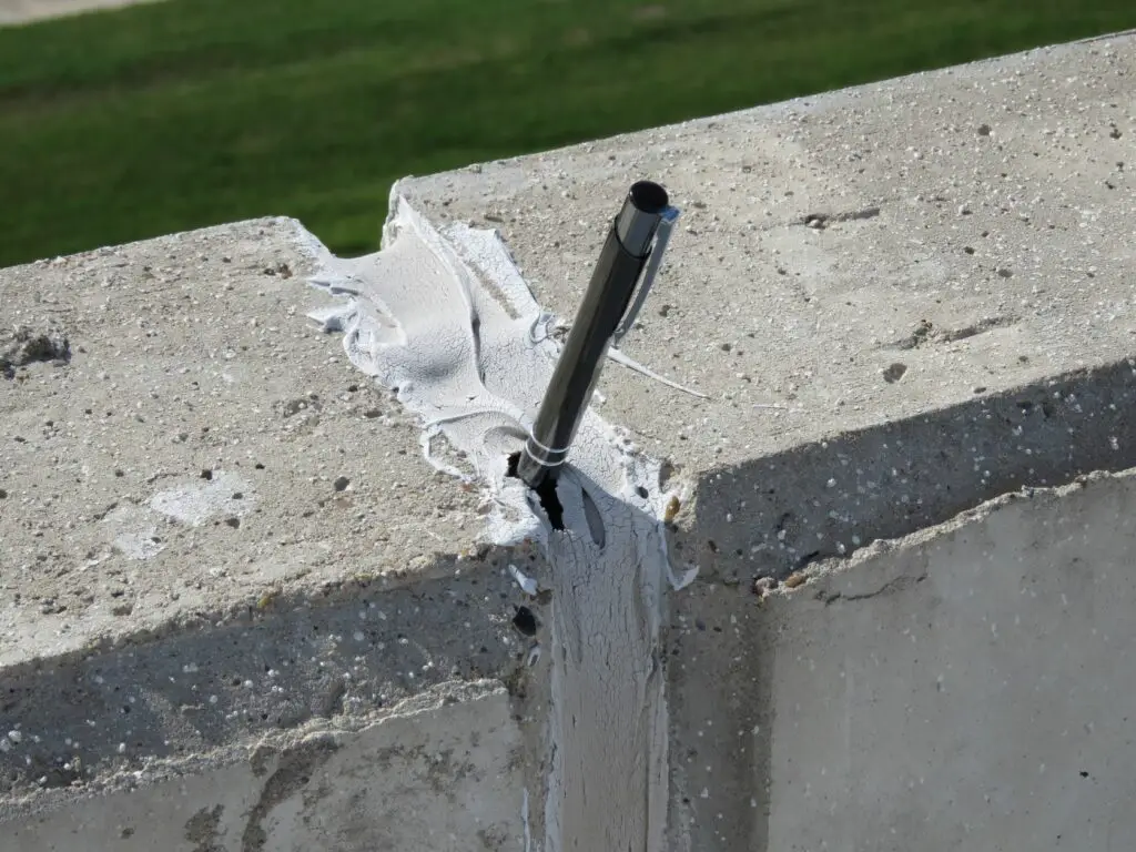 This is a pen inserted into a hole caused by cohesive sealant failure in the joint between two tilt-up wall panels.