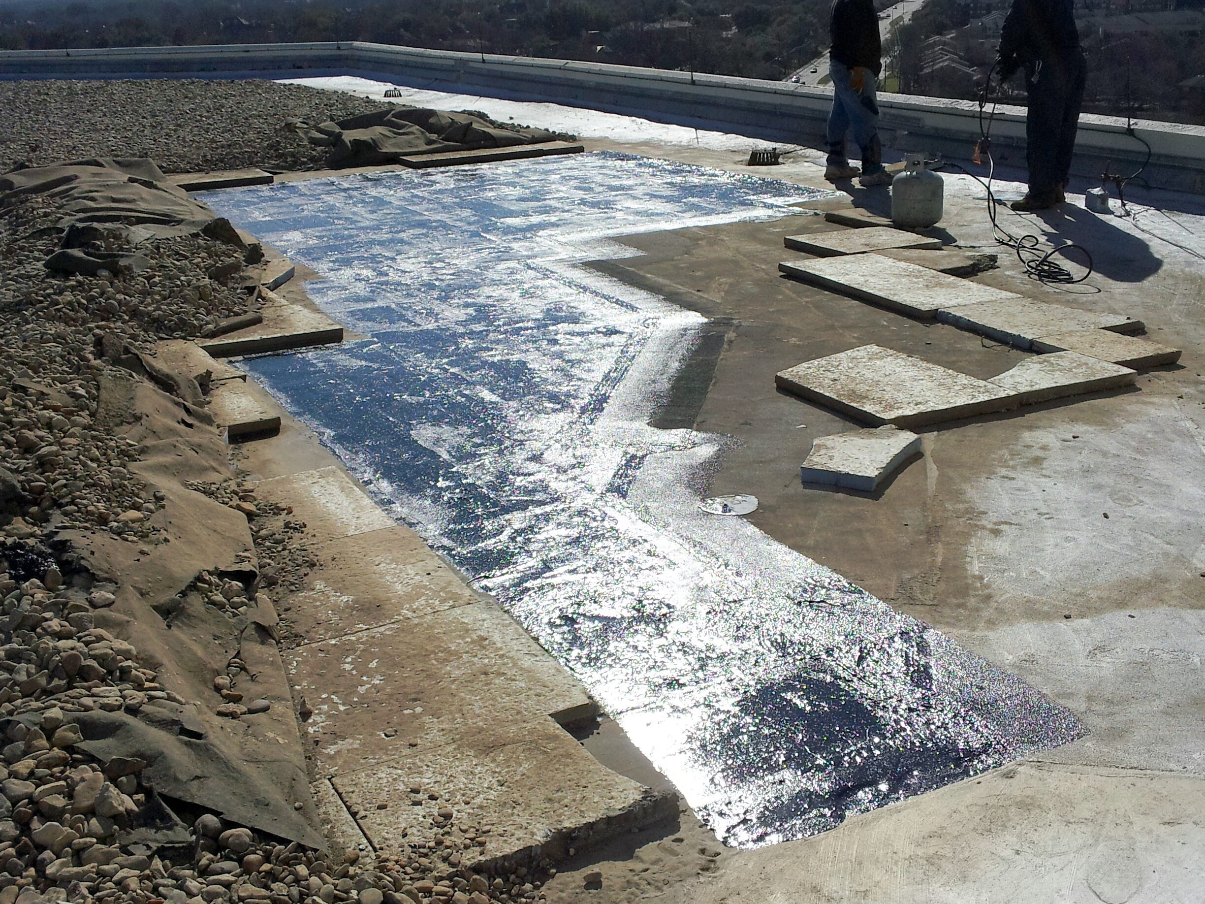 Filter fabric separates ballast stone from the insulation on a protected membrane roof (Left side of picture).