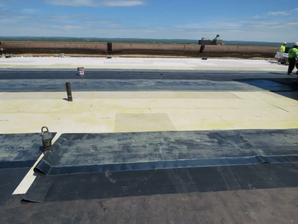 Waiting for the EPDM membrane adhesive to set up before installing these sheets on a fully-adhered EPDM roof 