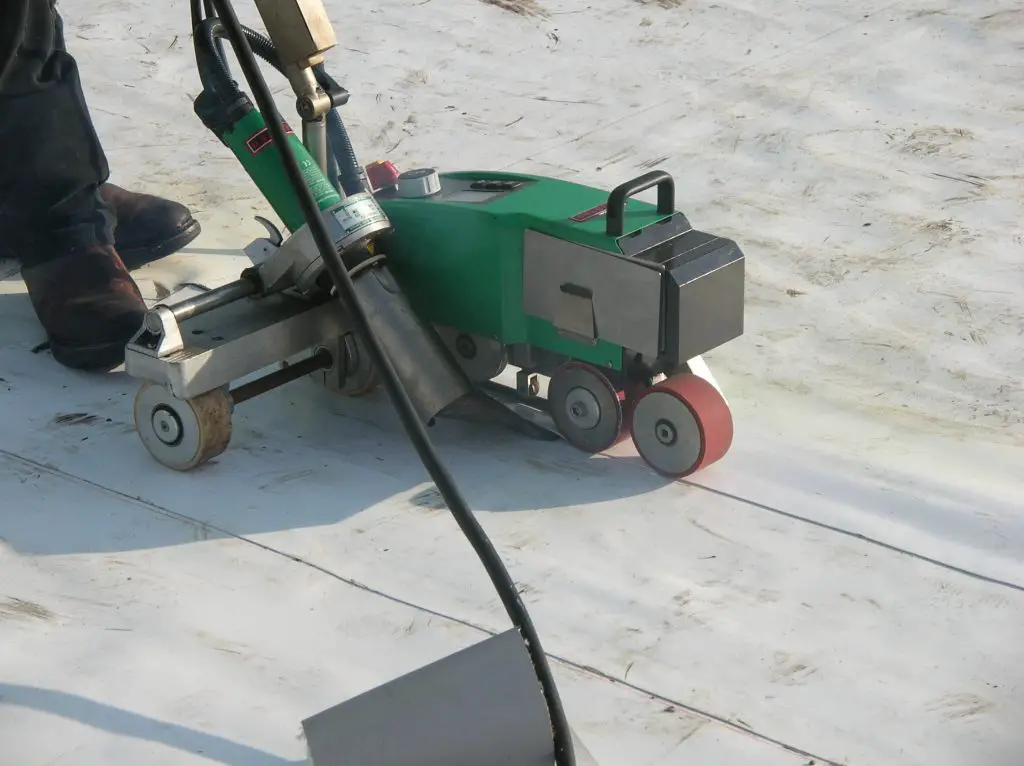 Heat-welding a field seam during the installation of a PVC roof membrane.