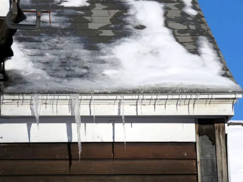 An ice dam on an asphalt shingle roof.