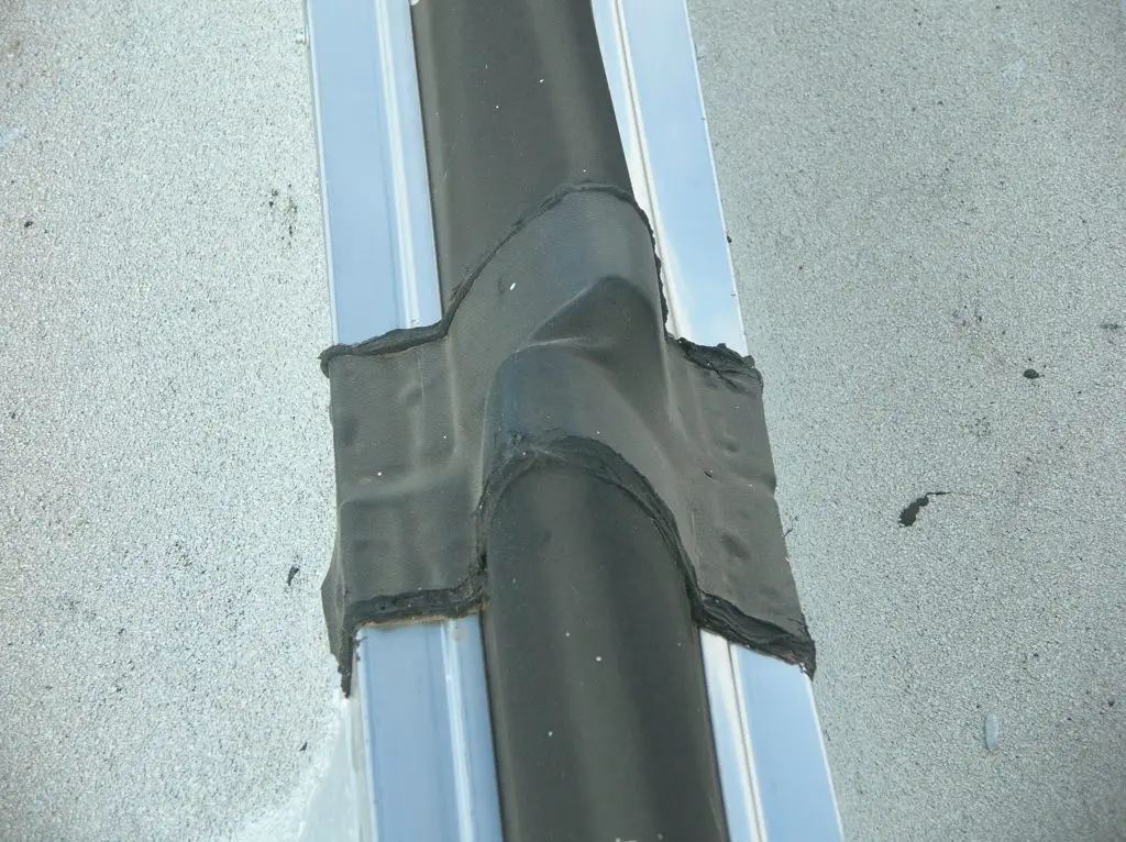 Top view of a curbed expansion joint, showing the joint between sections of the expansion joint cover.