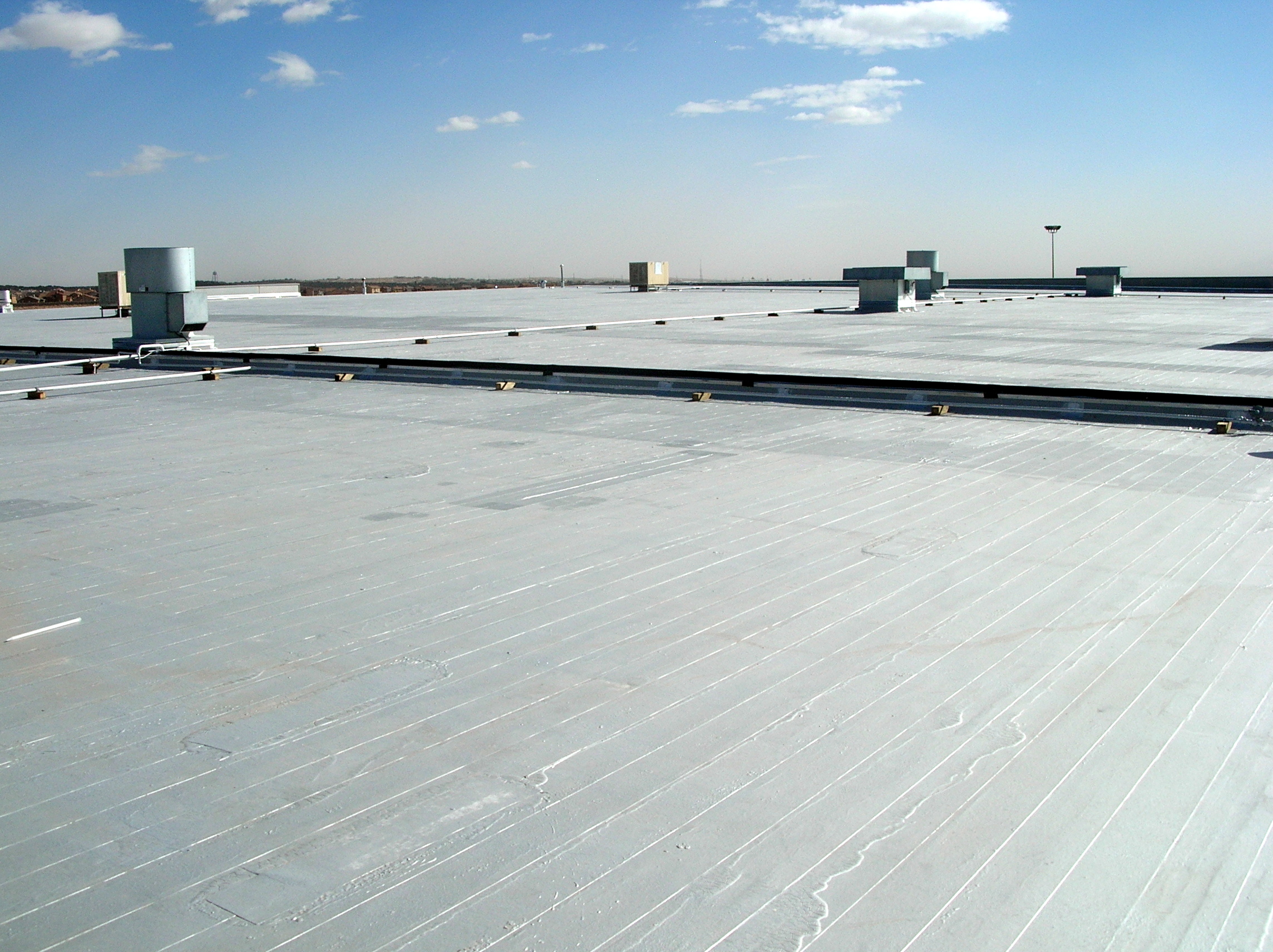 Low-slope roof: an emulsion-surfaced asphalt built-up roof with aluminum roof coating.