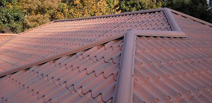 Metal roof tiles designed to look like clay roof tiles.