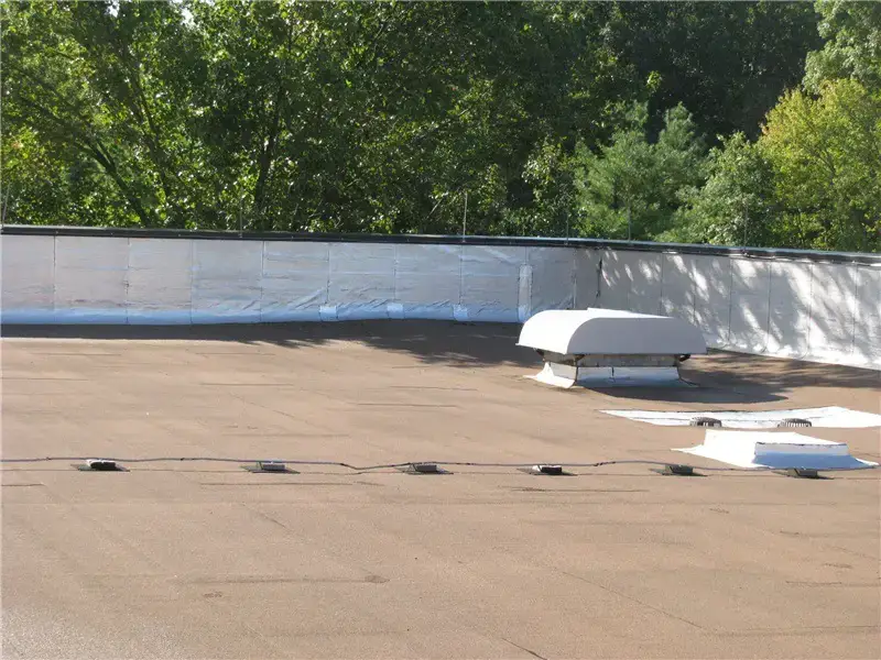 modified bitumen roof with tan granule surface.