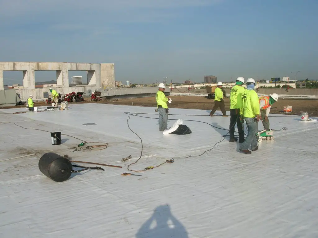 Installation of PVC roofing in progress.