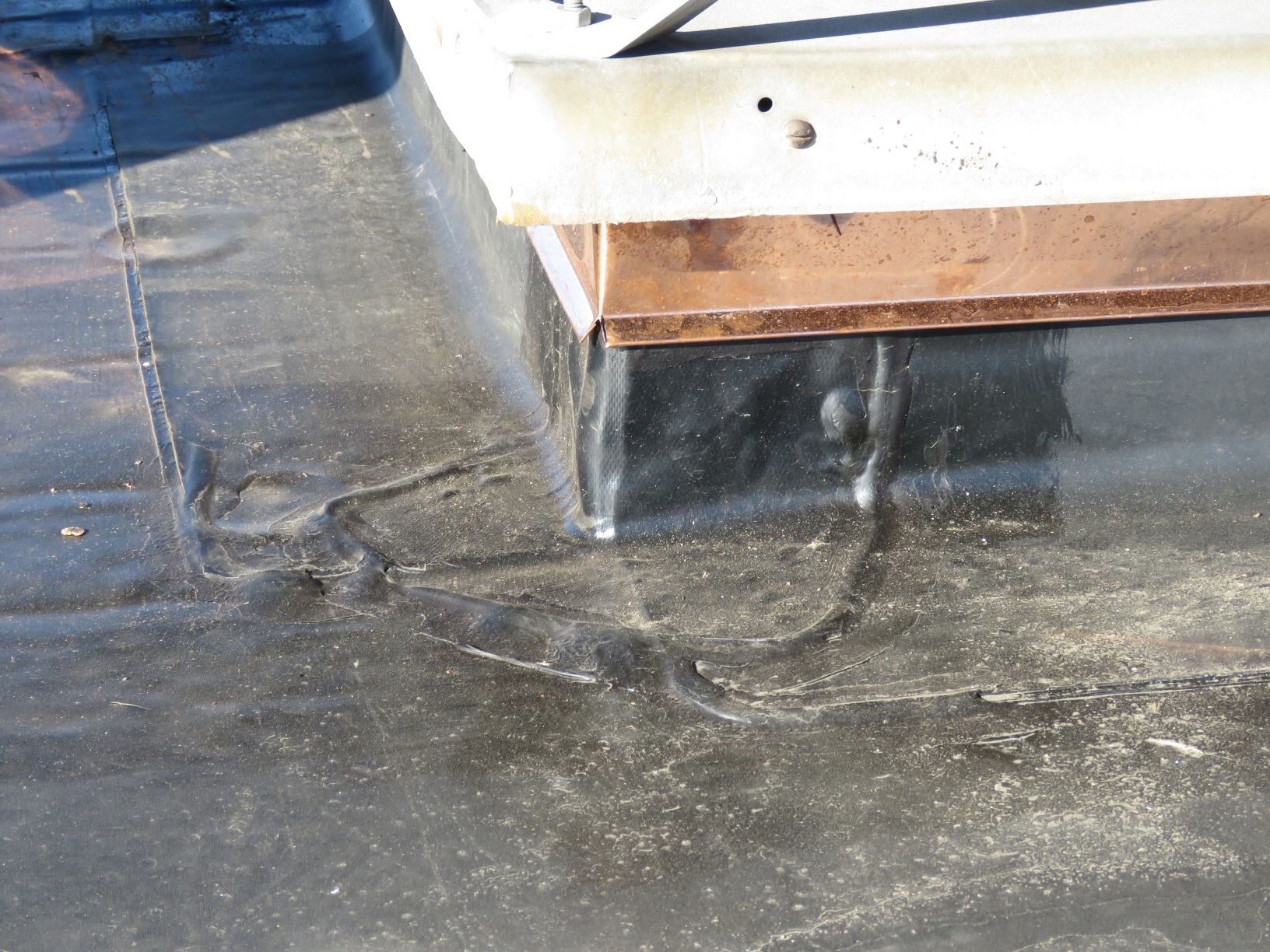 An uncured EPDM curb corner patch. See how easily it conforms to the angle changes - even at the air bubble (which should have been rolled out).