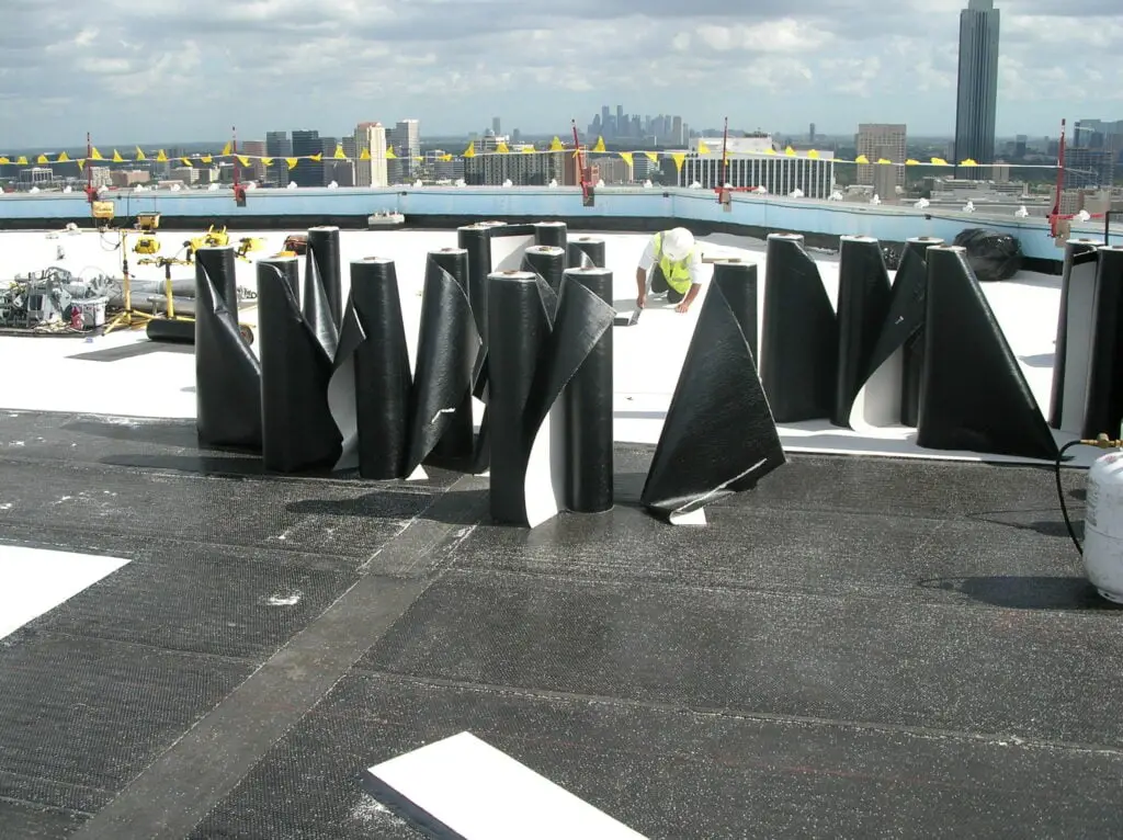 rolls of modified bitumen standing on a roof.