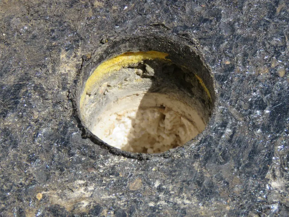 Layers of roof insulation visible in a roof core sample hole.
