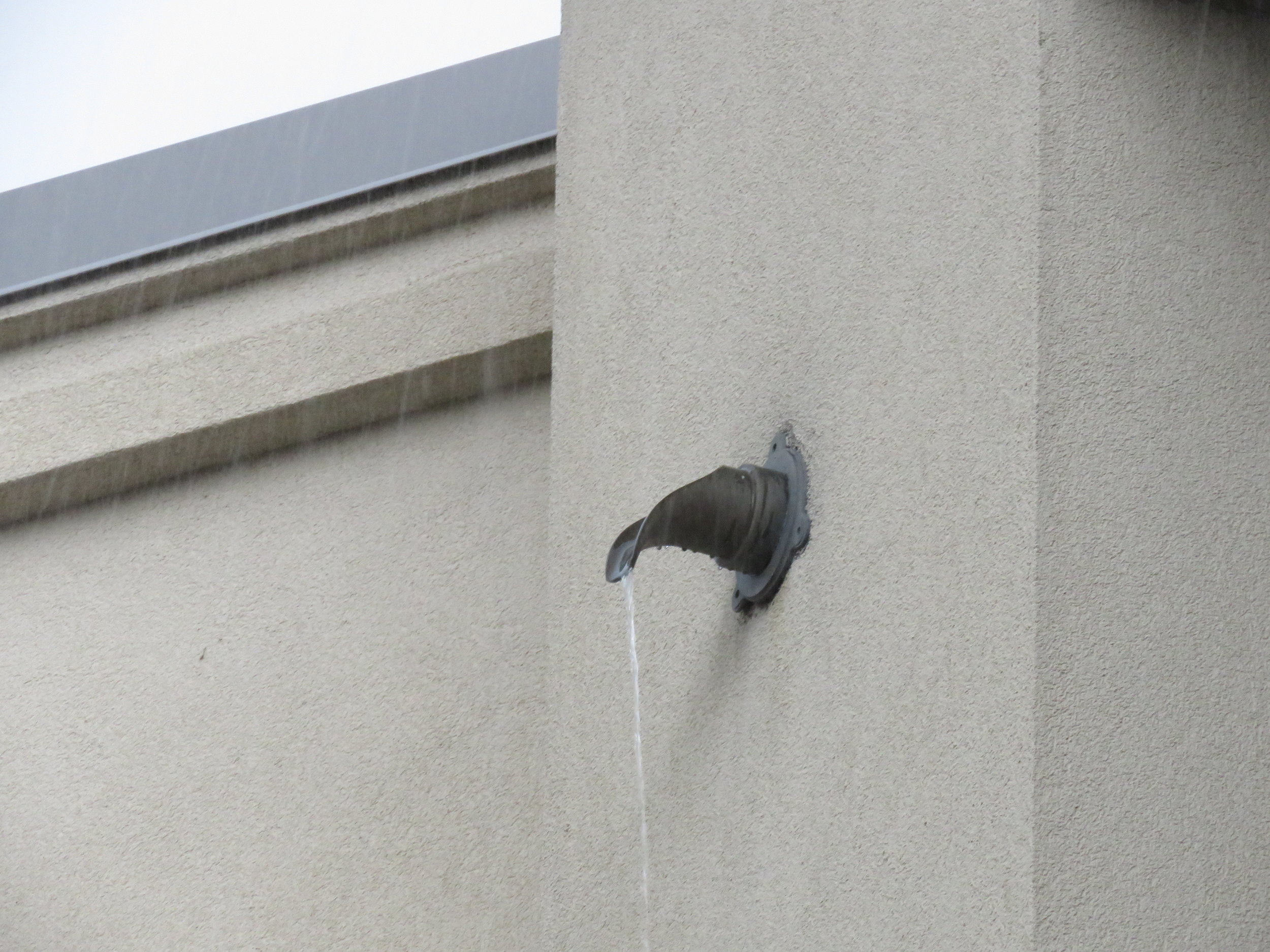 A roof scupper doing its job.