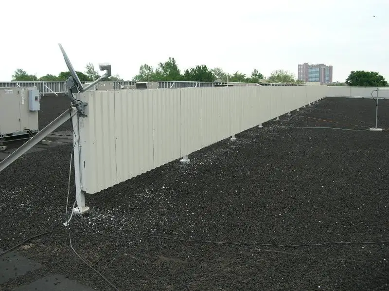 Rooftop screen wall on a slag-surfaced built-up roof.