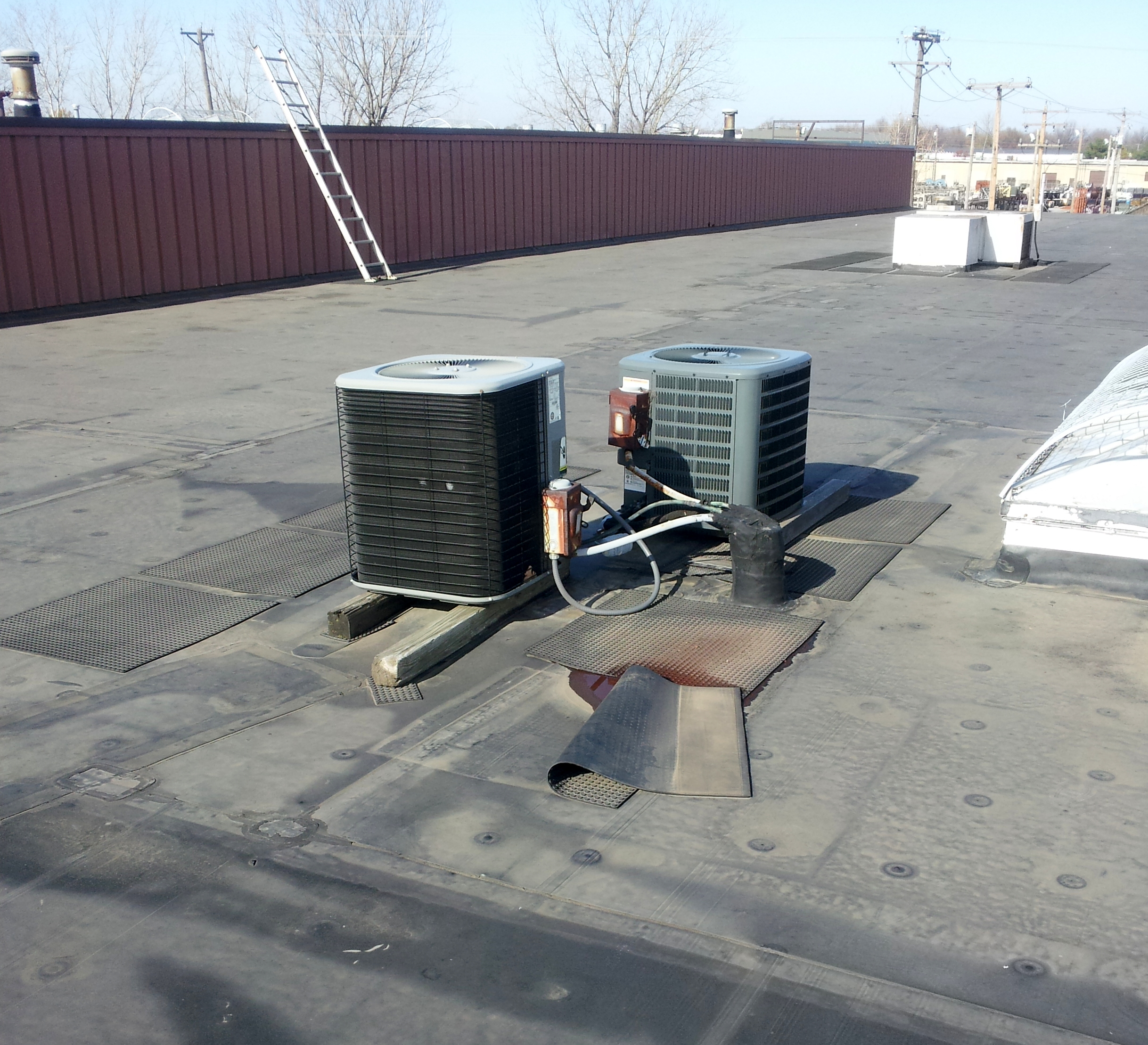 Two small rooftop units on sleeper supports.