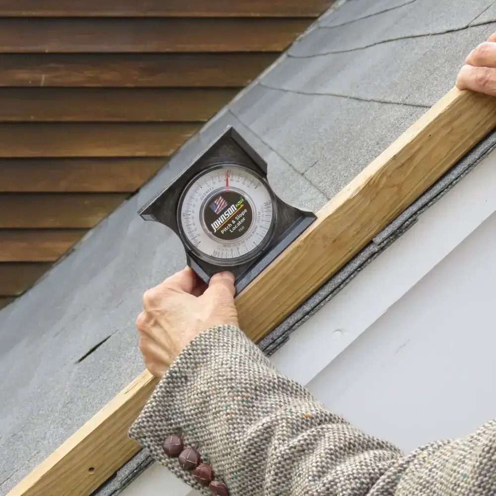 using a slope finder to find the roof pitch, which is the first step to finding the roof pitch multiplier