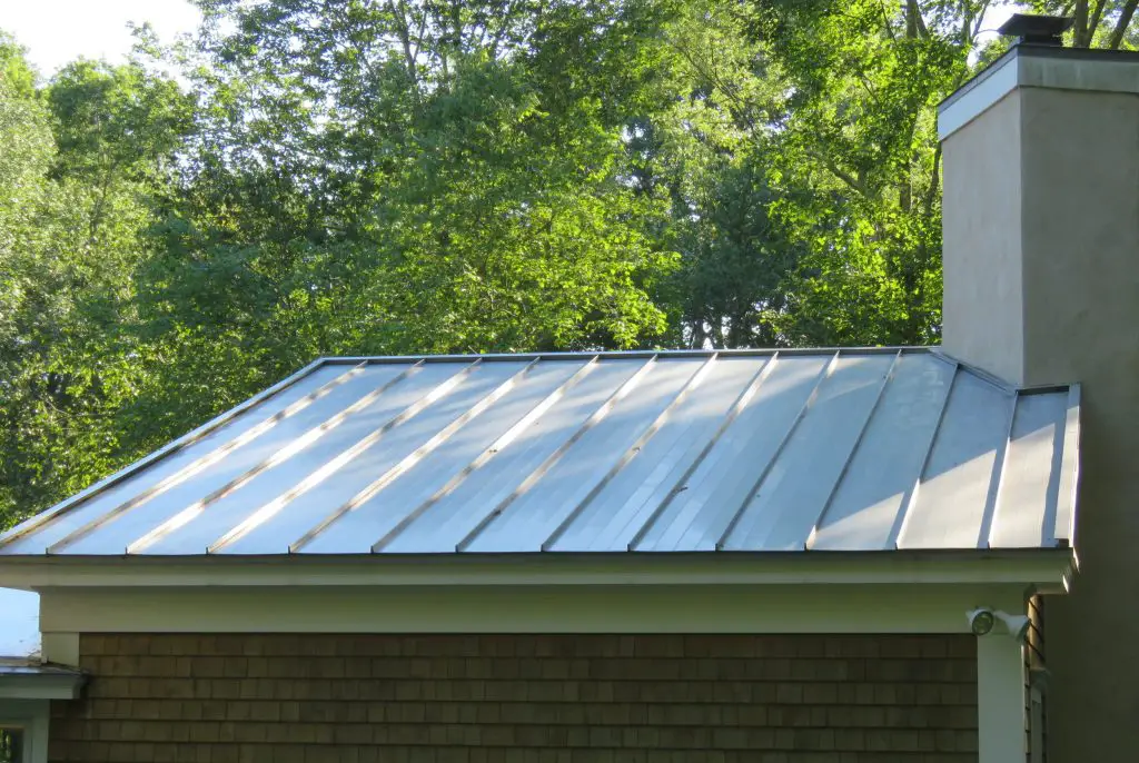 A standing seam metal roof with an energy efficient reflective white coating.