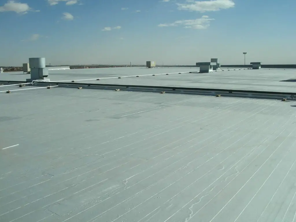 This low-slope roof is required to have a minimum pitch of 1/4 inch in every 12 inches to ensure water drainage.