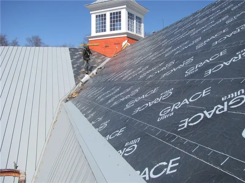 Peel-and-stick roofing underlayment applied to the plywood roof deck during the installation of a standing seam metal roof.